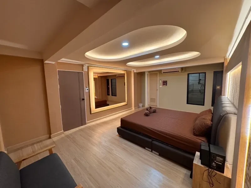 KK Club Khon Kaen private room with large bed, full-length mirror and mood lighting for B2B nuru massage